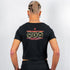 Schwarzes "Off Track" Crop Top von Technostoff getragen von einem Raver Mann, Rückansicht